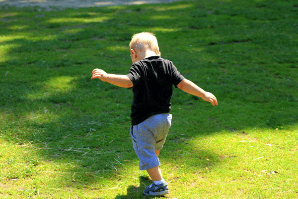 Bambino che cammina nel prato